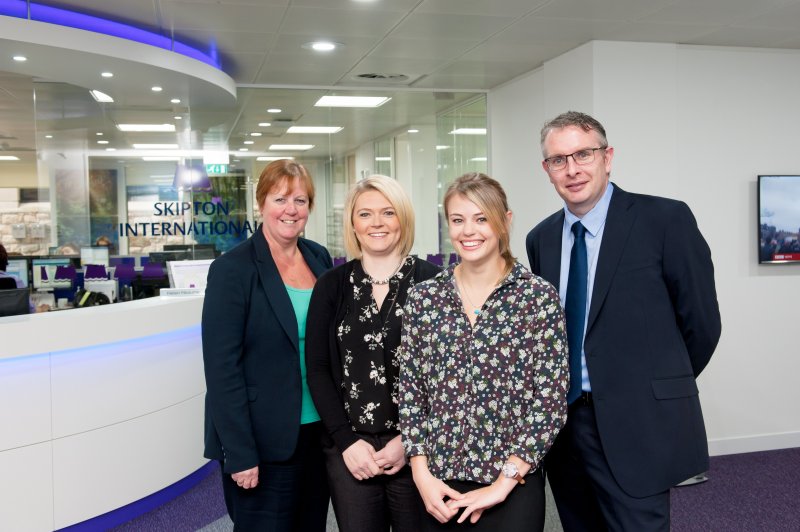 Four people in Skipton International's Lobby