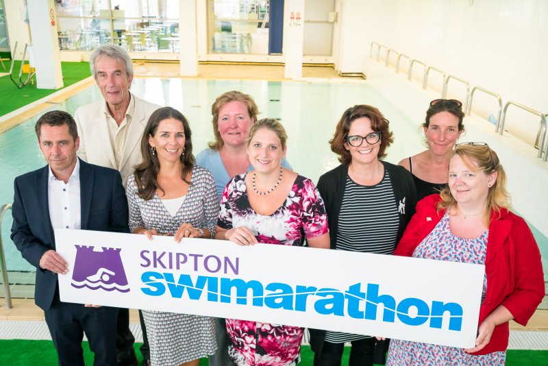 People holding Swimarathon sign