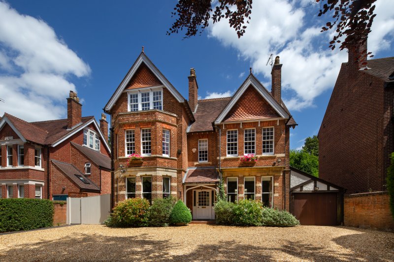 Large home with blue skies and clouds