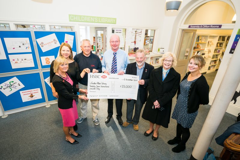 people smiling with large cheque