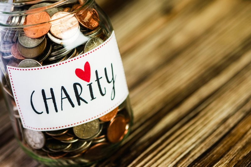 pennies in a jar with "charity" on the front