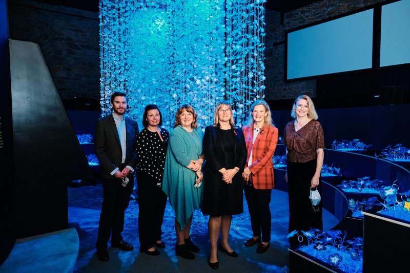 people smiling Infront of art work at Arthouse jersey