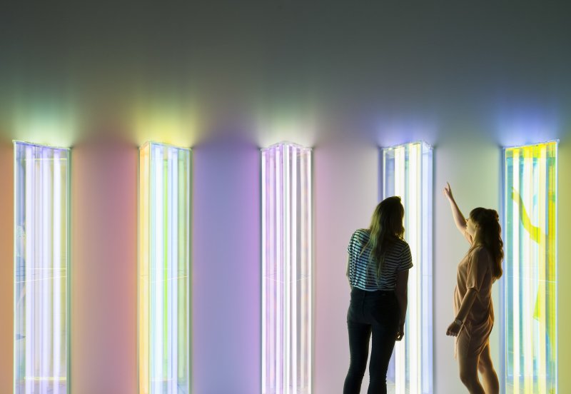 two people looking at coloured lighting