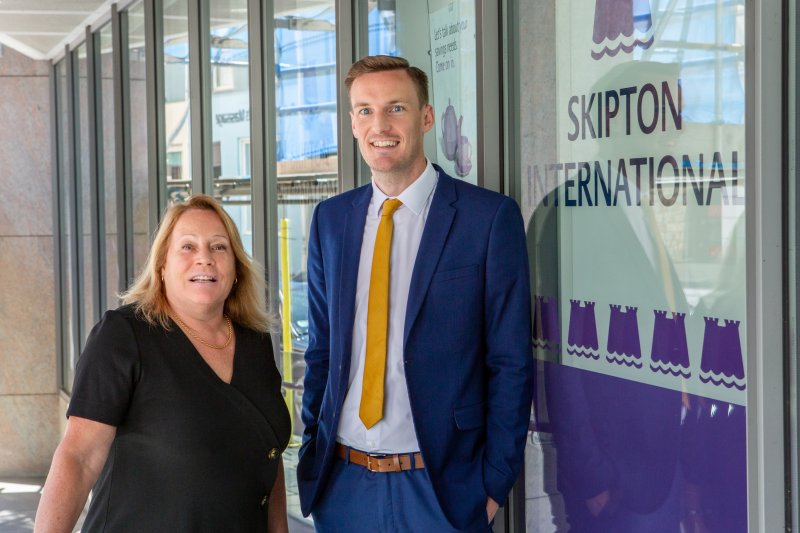 people smiling outside of Skipton office