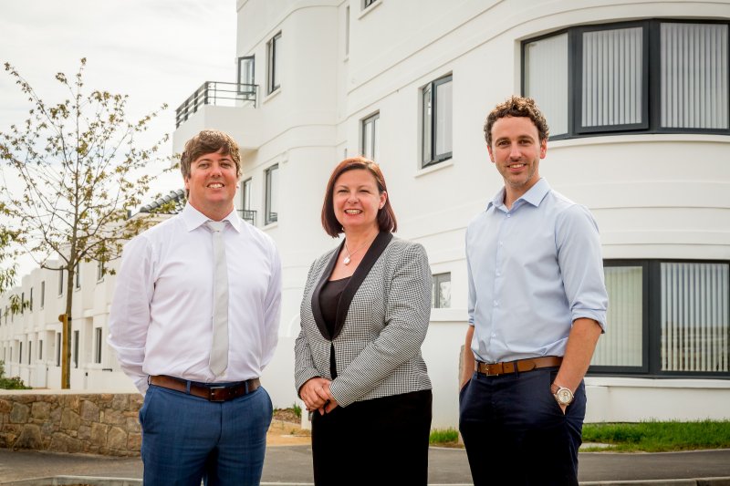 Three people smiling
